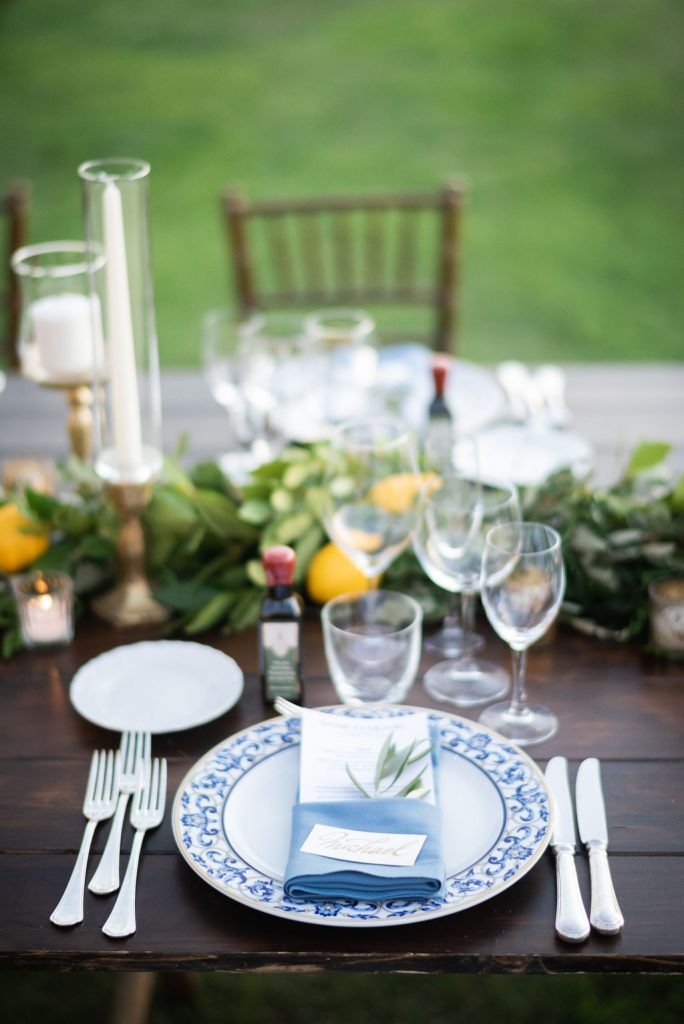 Al fresco dinner table with lemon and greenery